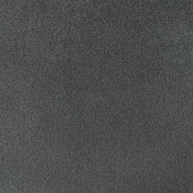 Close-up of deep charcoal-grey chenille with a fine softly mottled weave