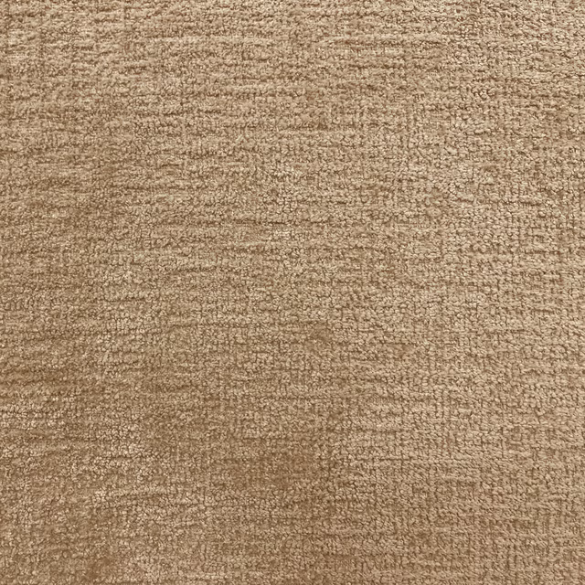 Warm taupe chenille with softly mottled horizontal texture and subtle beige flecks