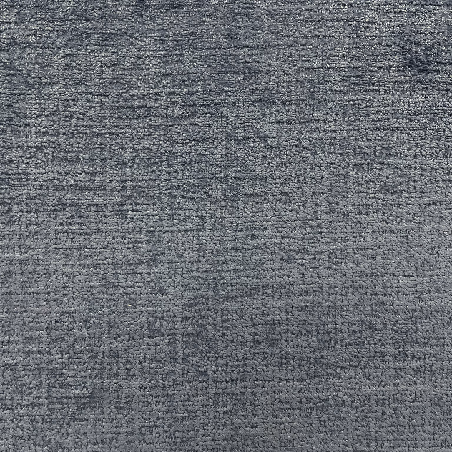 Deep charcoal-grey chenille with fine horizontal slubs and mottled tonal texture