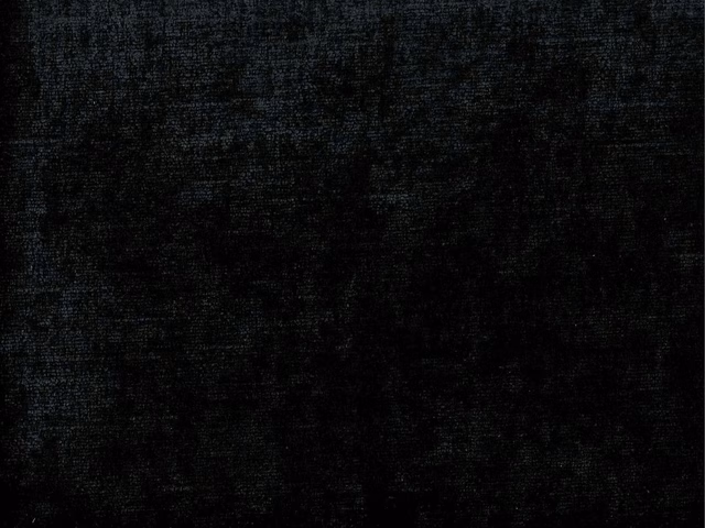 Near-black chenille swatch with faint charcoal bands and softly mottled woven texture