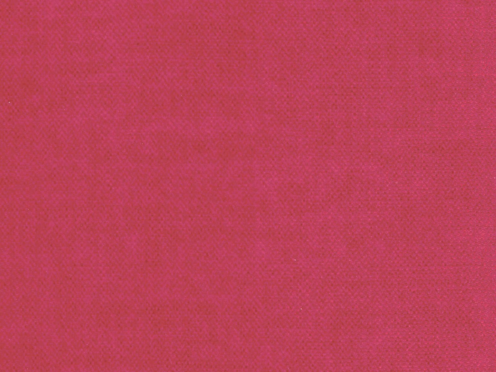 Close-up of saturated deep magenta pink velvet with subtle directional pile texture