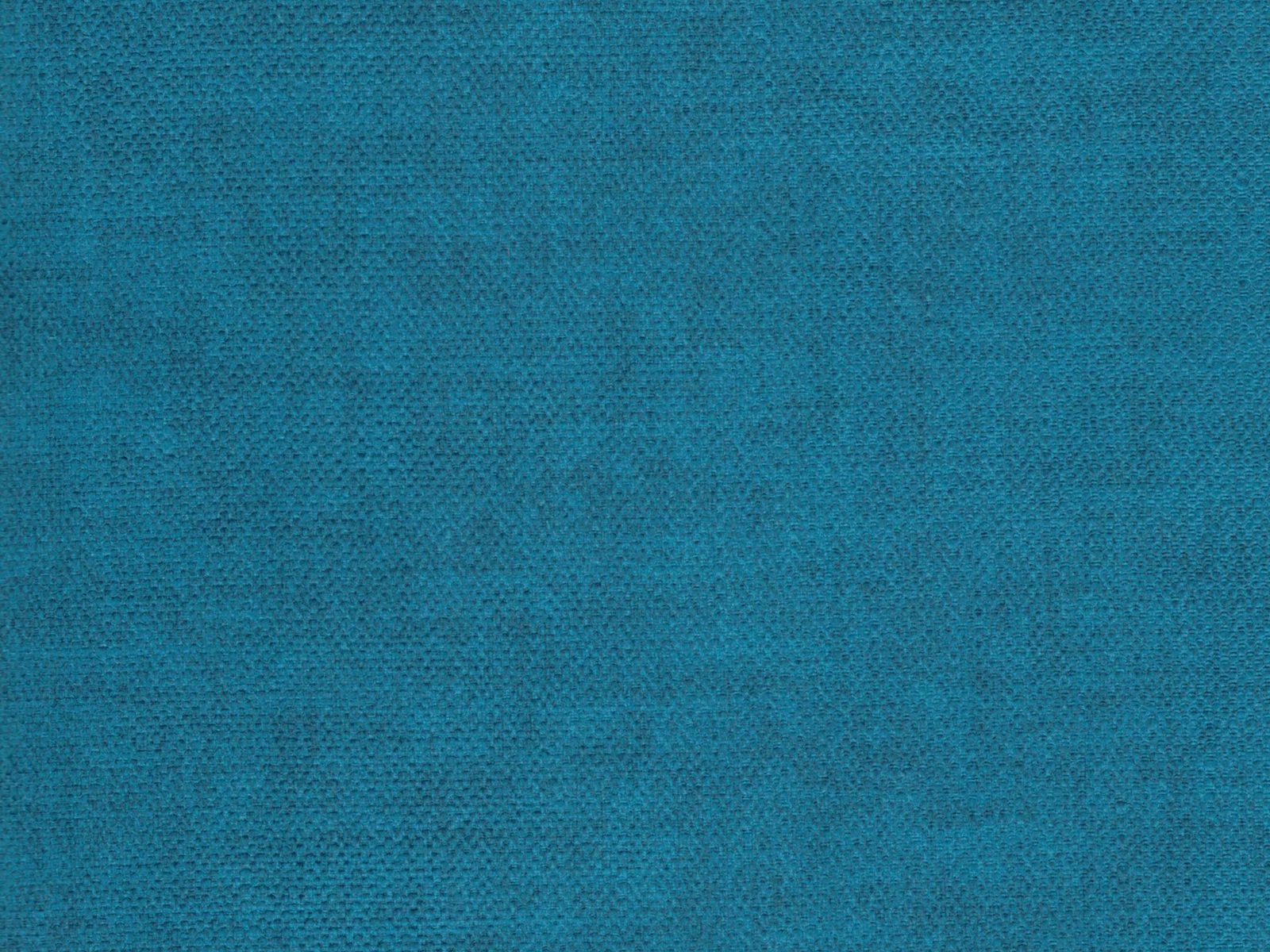 Close-up of turquoise-teal velvet with a softly mottled, directional pile
