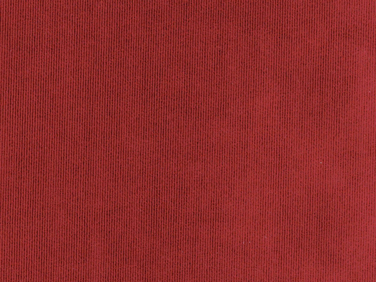 Close-up of deep crimson red velvet with fine vertical ribbed pile