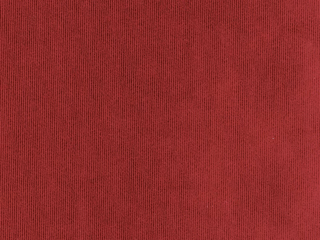 Close-up of deep crimson red velvet with fine vertical ribbed pile