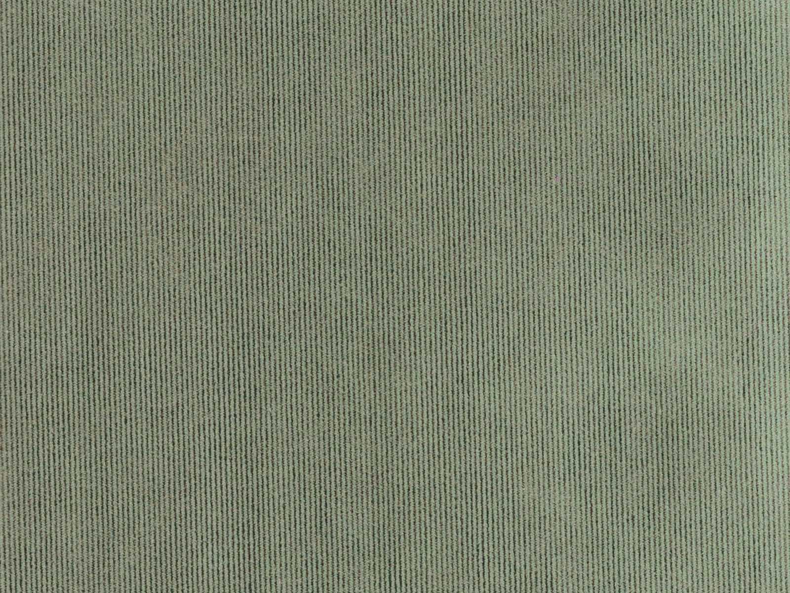 Muted sage-green velvet showing fine vertical pile and a softly shifting surface sheen