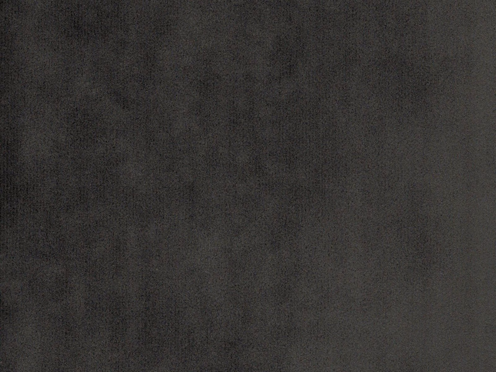 Deep charcoal-grey velvet swatch showing subtle nap shifts across its plain surface