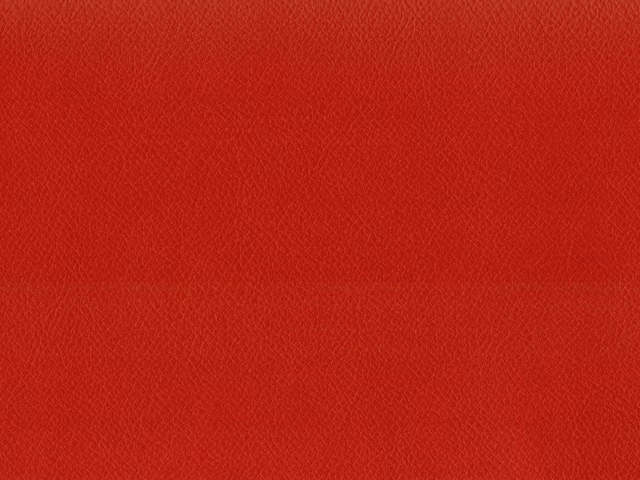 Close-up of scarlet red faux leather with a fine, pebbled grain