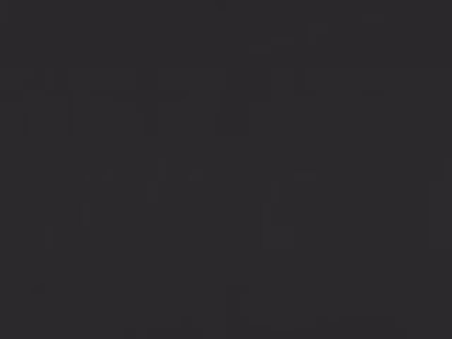 Deep charcoal-black faux leather swatch with a smooth, subtly low-sheen surface