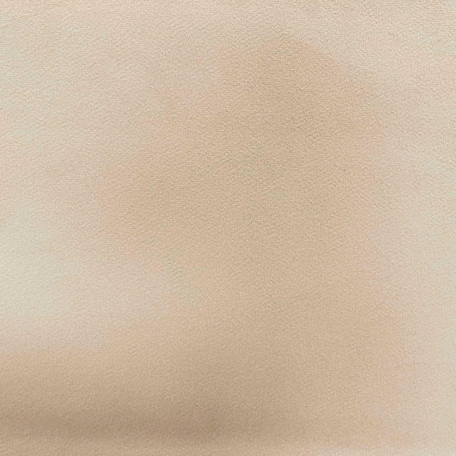 Pale warm-beige plain velvet showing fine pile and subtle directional shading
