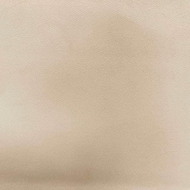Pale warm-beige plain velvet showing fine pile and subtle directional shading