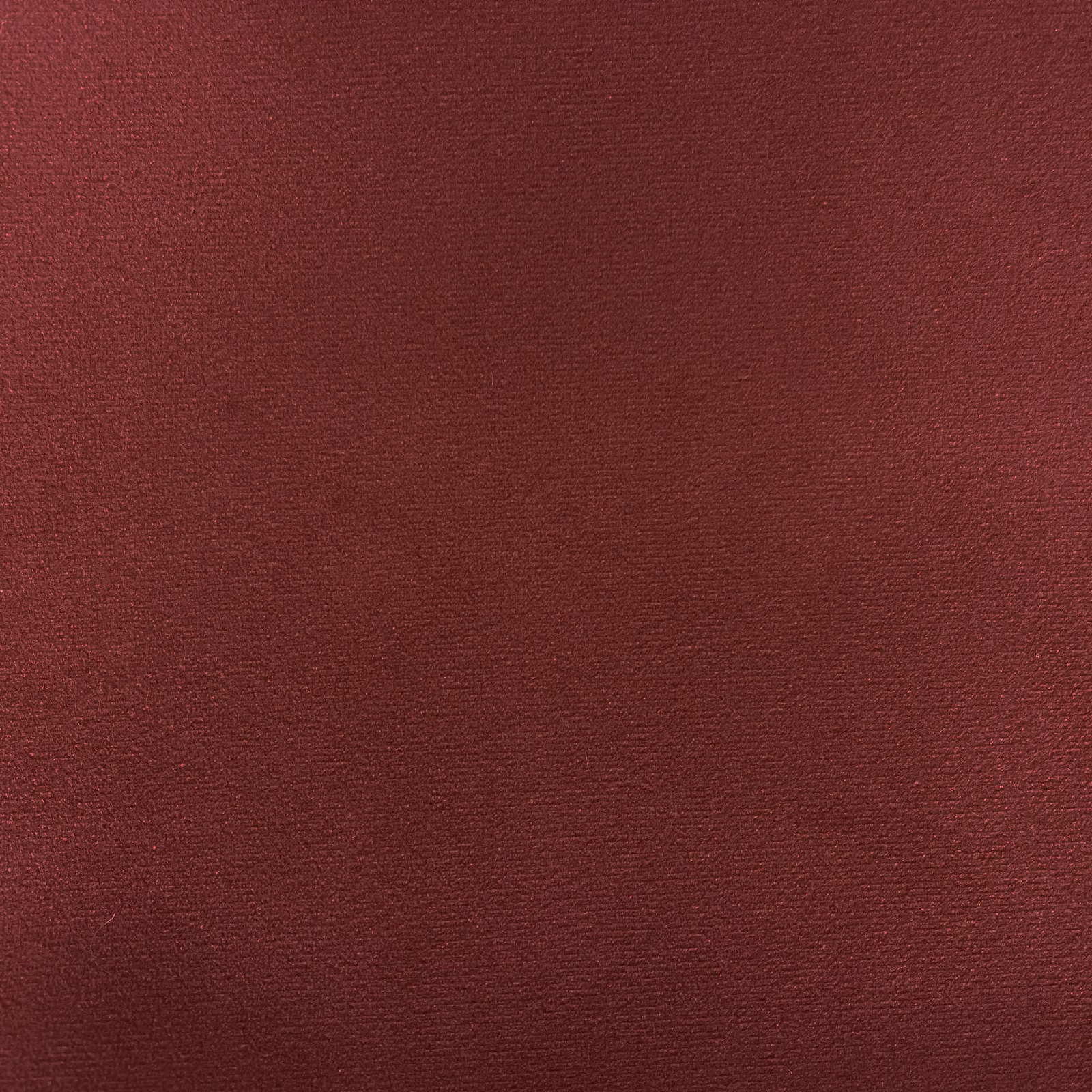 Deep burgundy velvet with a subtle brushed pile and softly shifting red texture