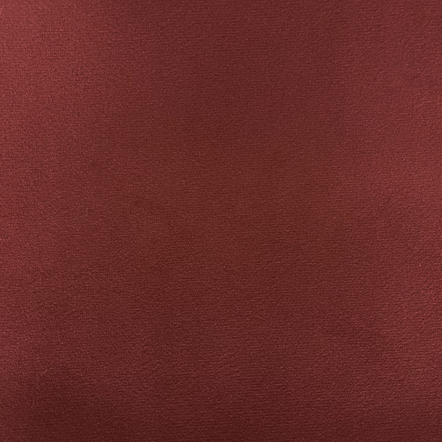 Deep burgundy velvet with a subtle brushed pile and softly shifting red texture