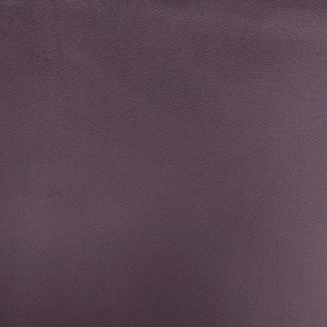 Close-up of deep muted plum-mauve velvet with softly shaded, fine nap