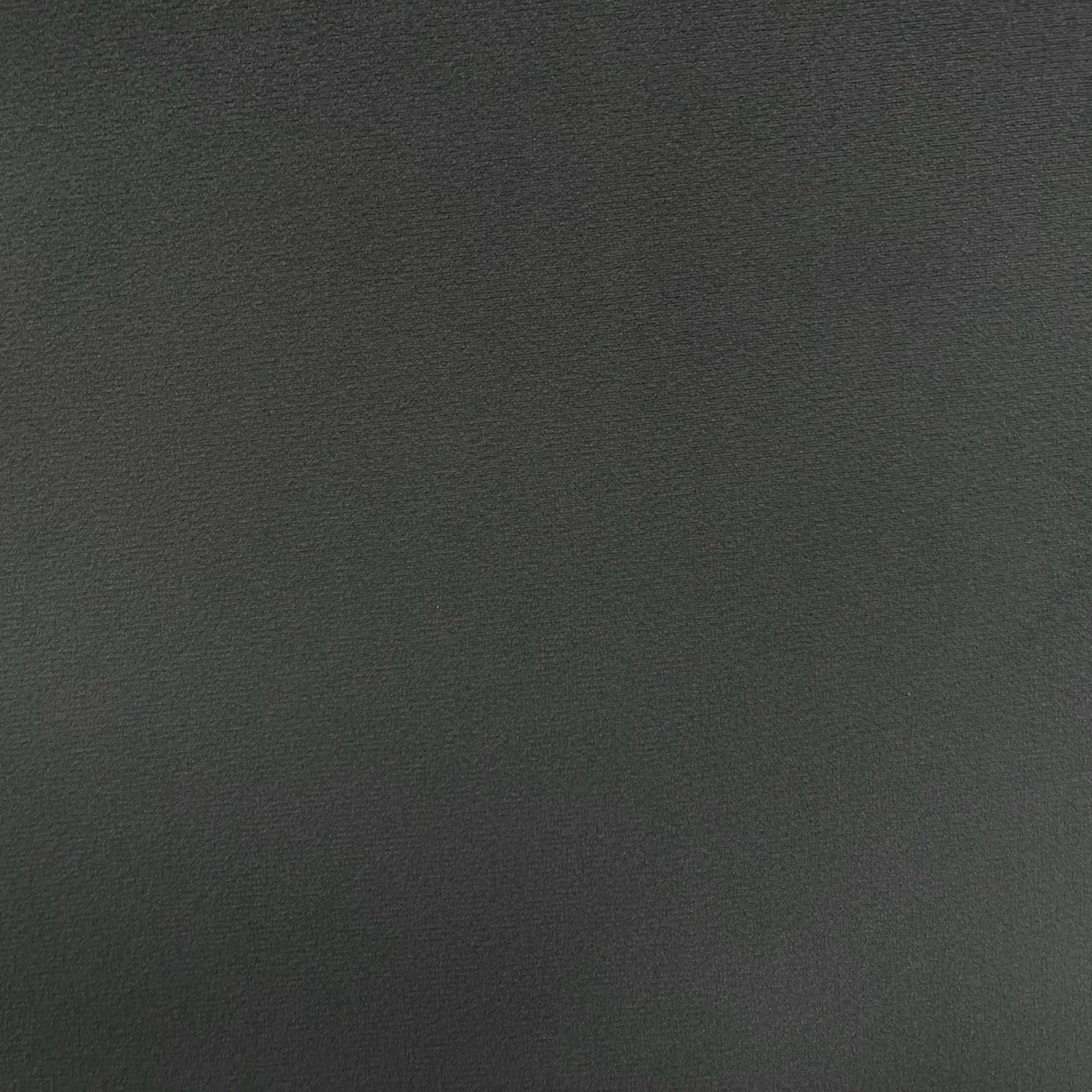 Deep green-charcoal velvet with fine pile and subtle directional sheen