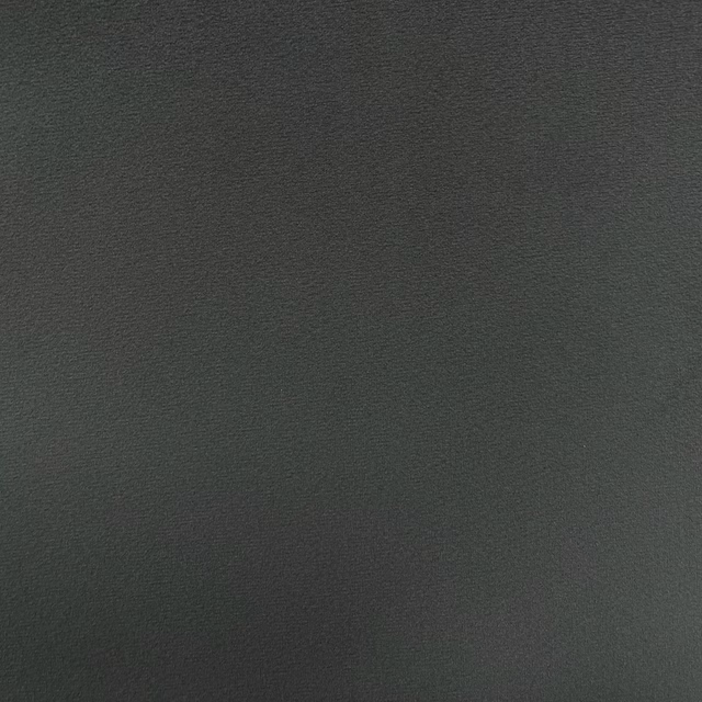 Deep green-charcoal velvet with fine pile and subtle directional sheen