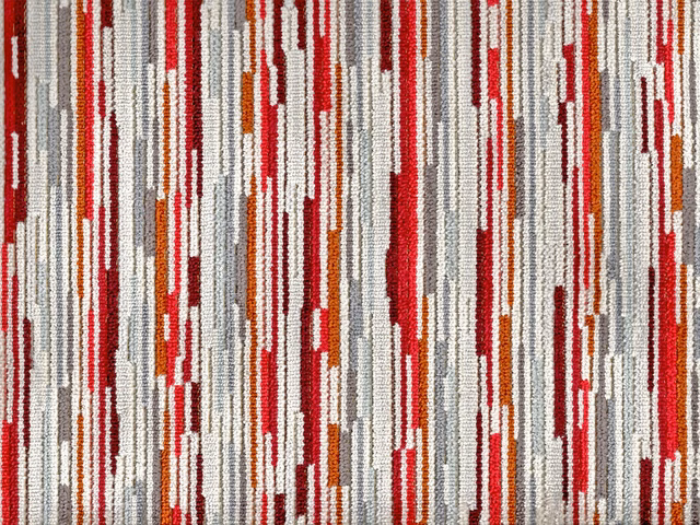 Close-up of red, orange, grey and white broken vertical velvet stripes