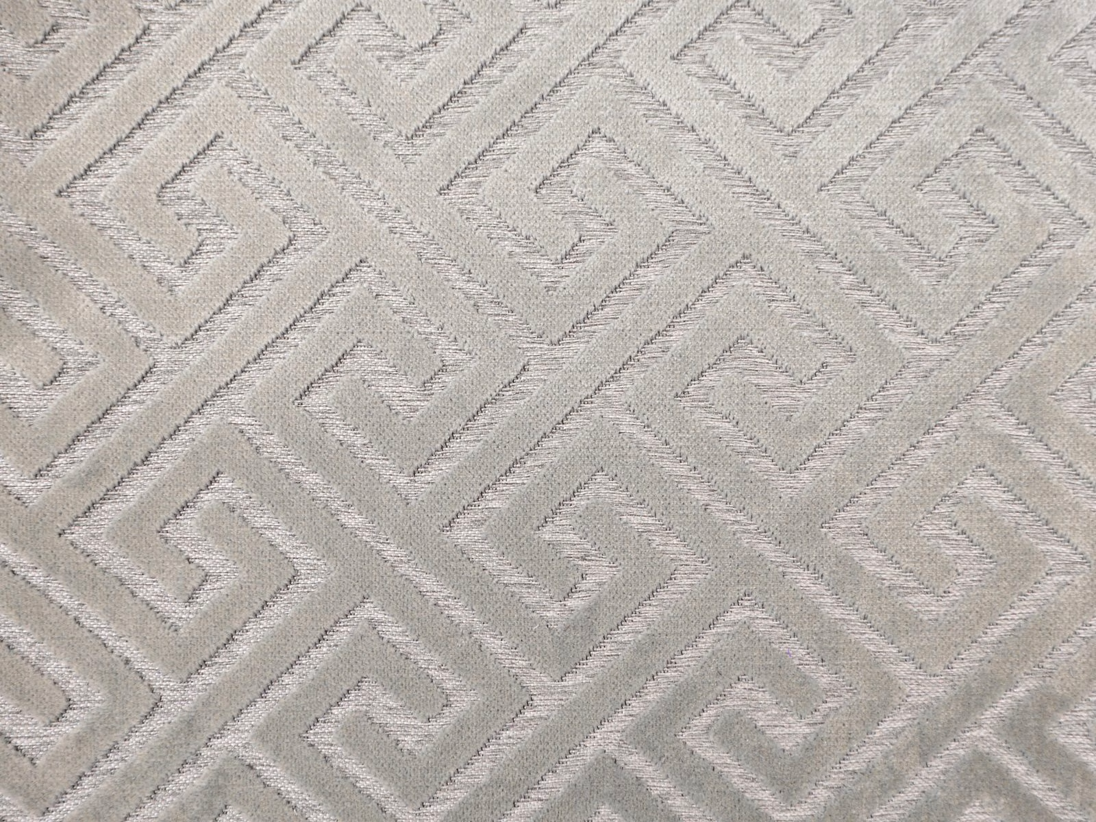 Pale greige velvet with a raised interlocking angular maze pattern and subtle sheen
