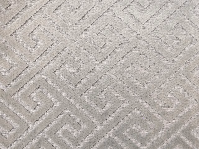 Pale greige velvet with a raised interlocking angular maze pattern and subtle sheen