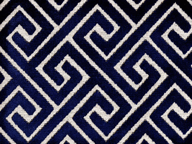 Deep navy velvet with ivory interlocking maze lines and a softly textured pile