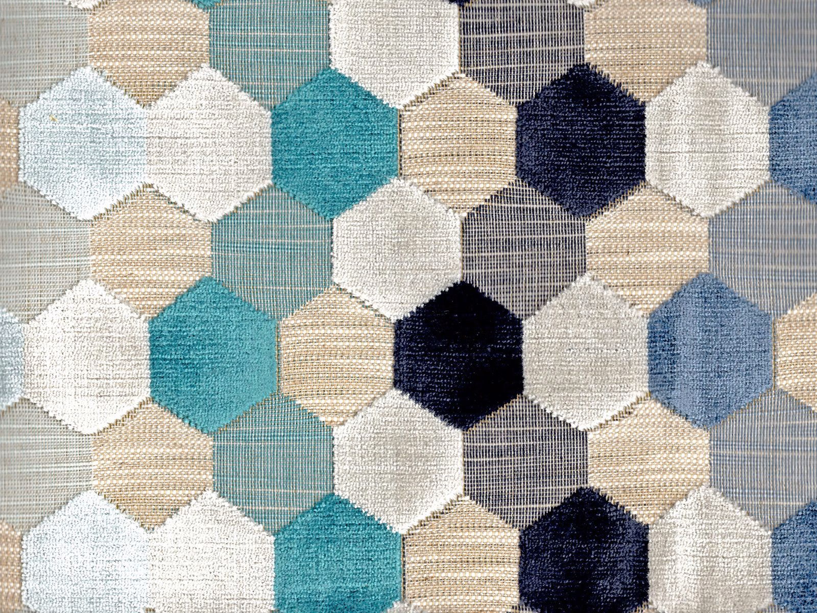 Teal, navy, ivory and beige hexagons across a textured velvet swatch