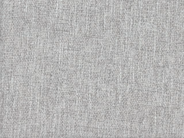 Pale grey chenille with fine dark-and-light woven texture in close-up