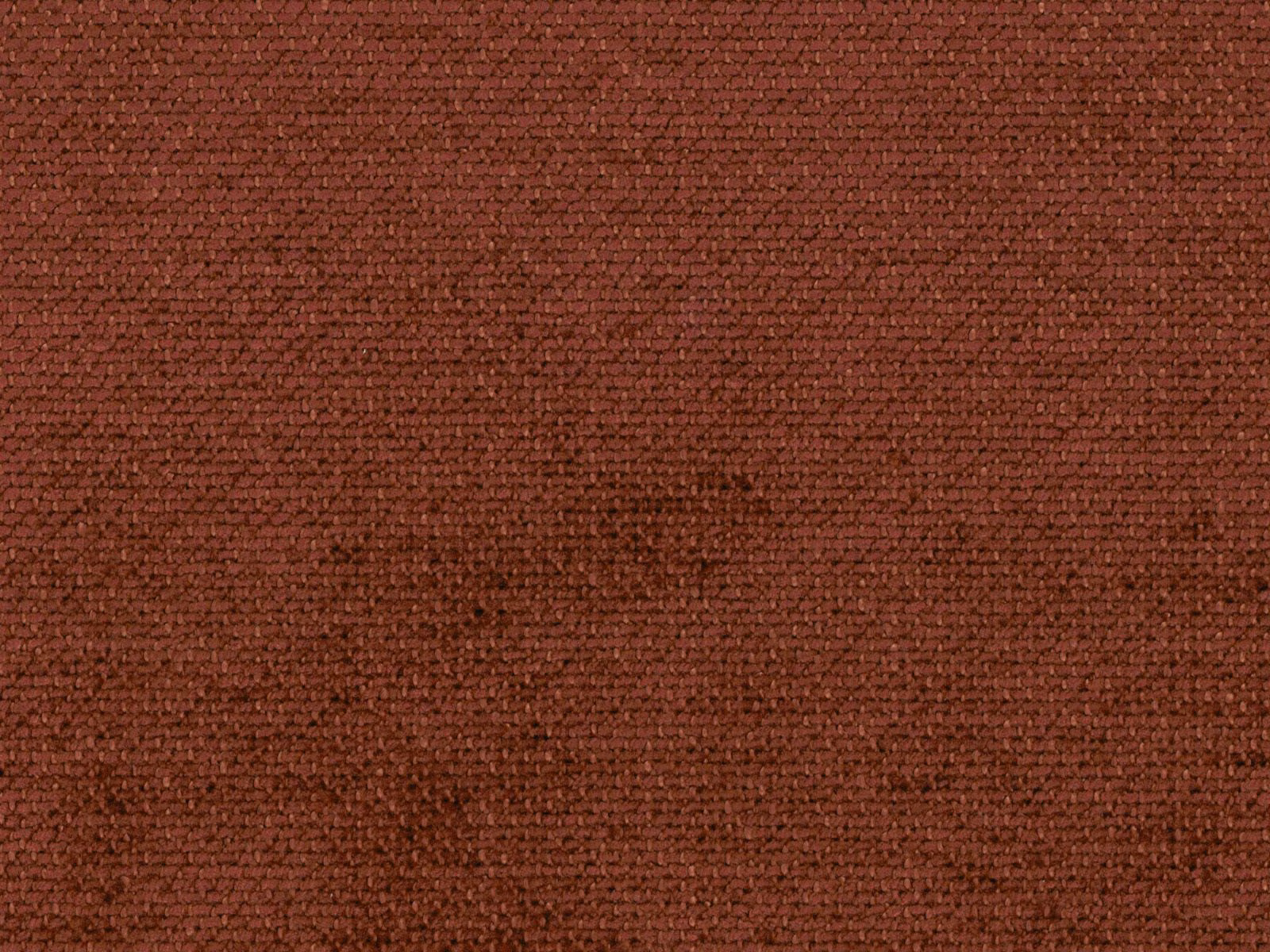 Close-up of deep russet terracotta chenille with a dense, softly mottled weave