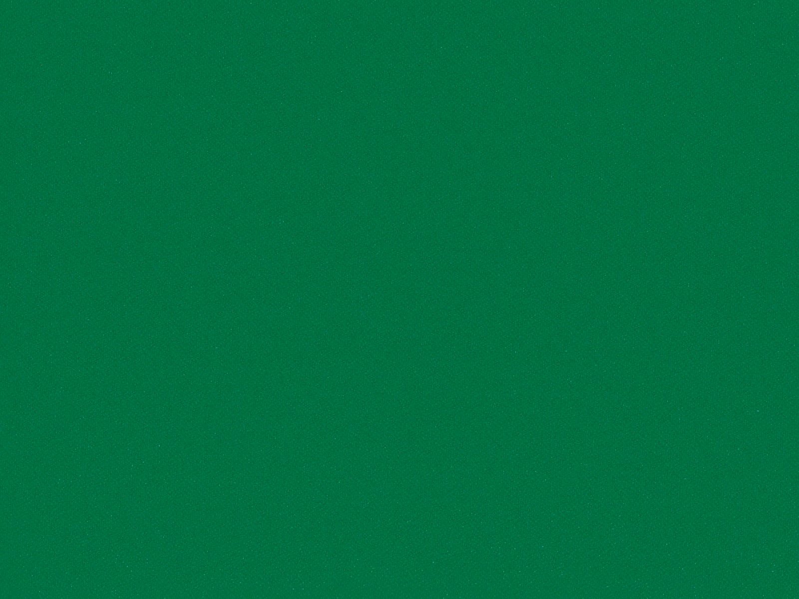 Close view of saturated emerald green fabric with a subtle flat-weave texture