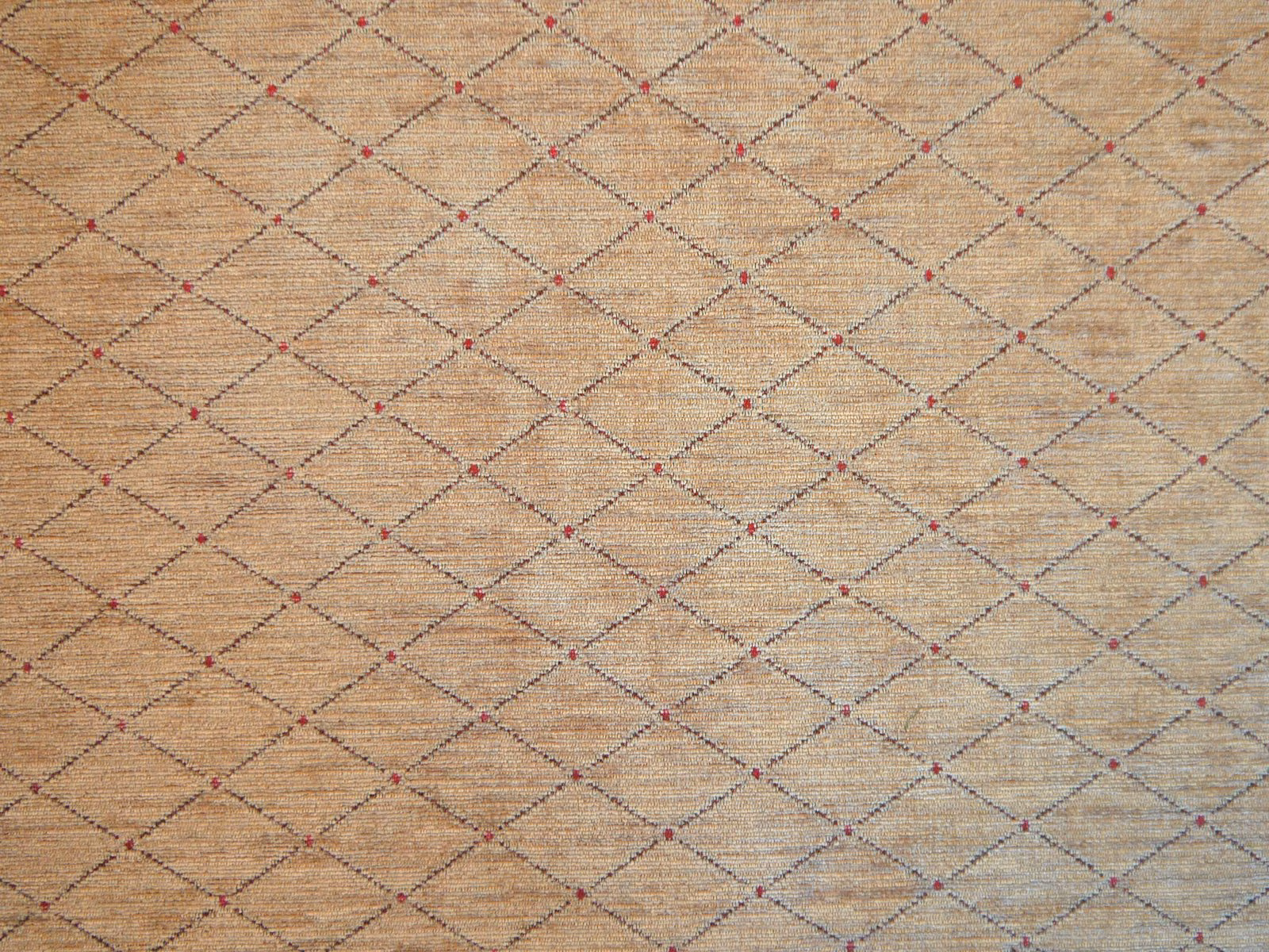 Warm oat-beige chenille with charcoal diamond lattice and tiny muted red woven accents