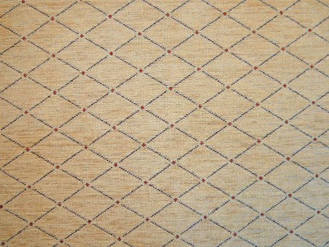 Warm oatmeal chenille with charcoal diamond lattice and tiny red accents