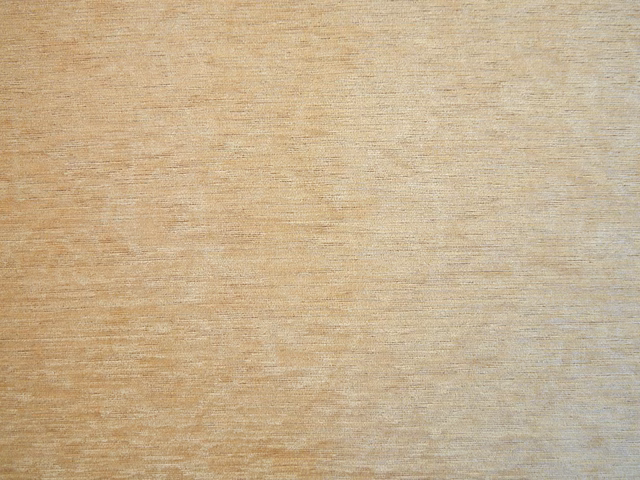 Warm sand-beige chenille swatch with subtle horizontal striations and mottled texture