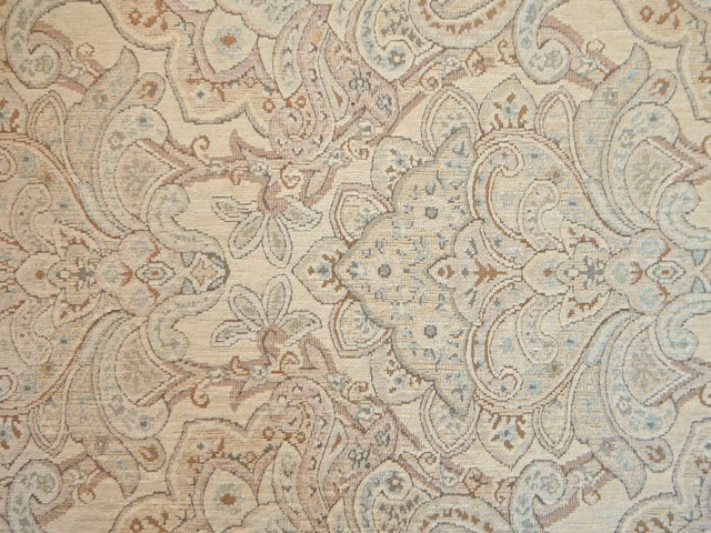 Pale beige chenille with blue-grey paisley, taupe curls and dusty rose floral details