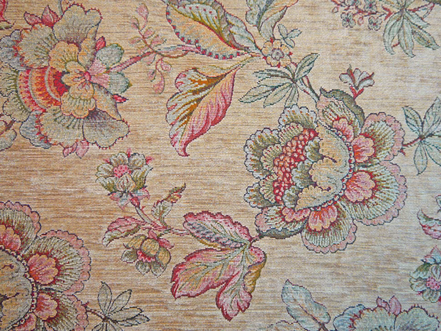 Muted burgundy and sage floral bouquets woven across a warm beige chenille ground