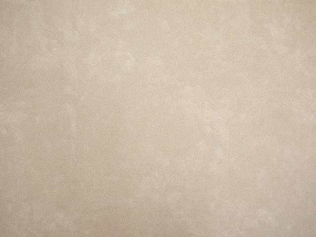 Pale warm taupe faux leather with a softly mottled cloudy surface