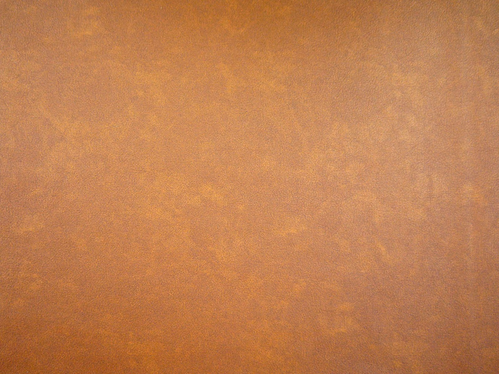 Warm caramel-brown faux leather with softly mottled copper and amber shading