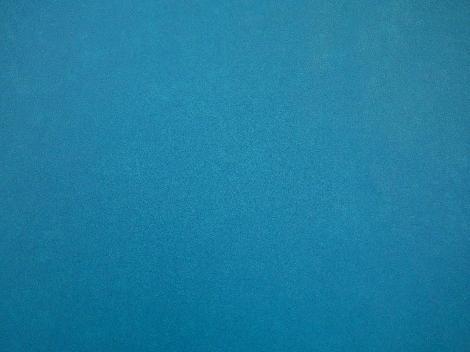 Deep turquoise teal faux leather with subtle cloudy tonal variation across its smooth surface