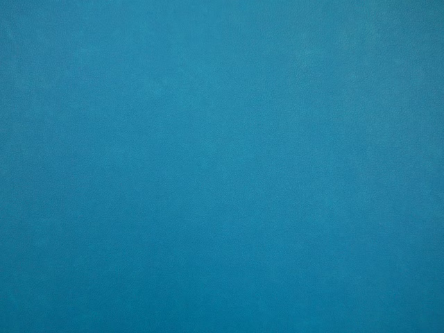 Deep turquoise teal faux leather with subtle cloudy tonal variation across its smooth surface