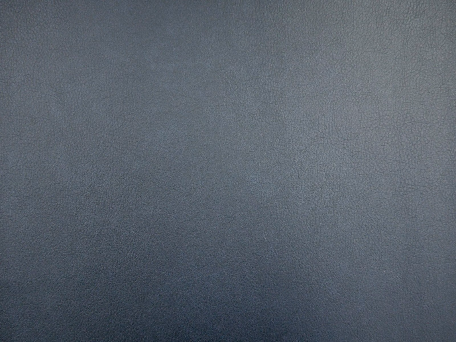 Deep blue-grey faux leather showing a softly pebbled, subtly tonal surface