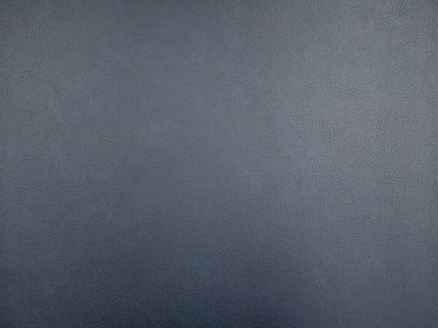 Deep blue-grey faux leather showing a softly pebbled, subtly tonal surface