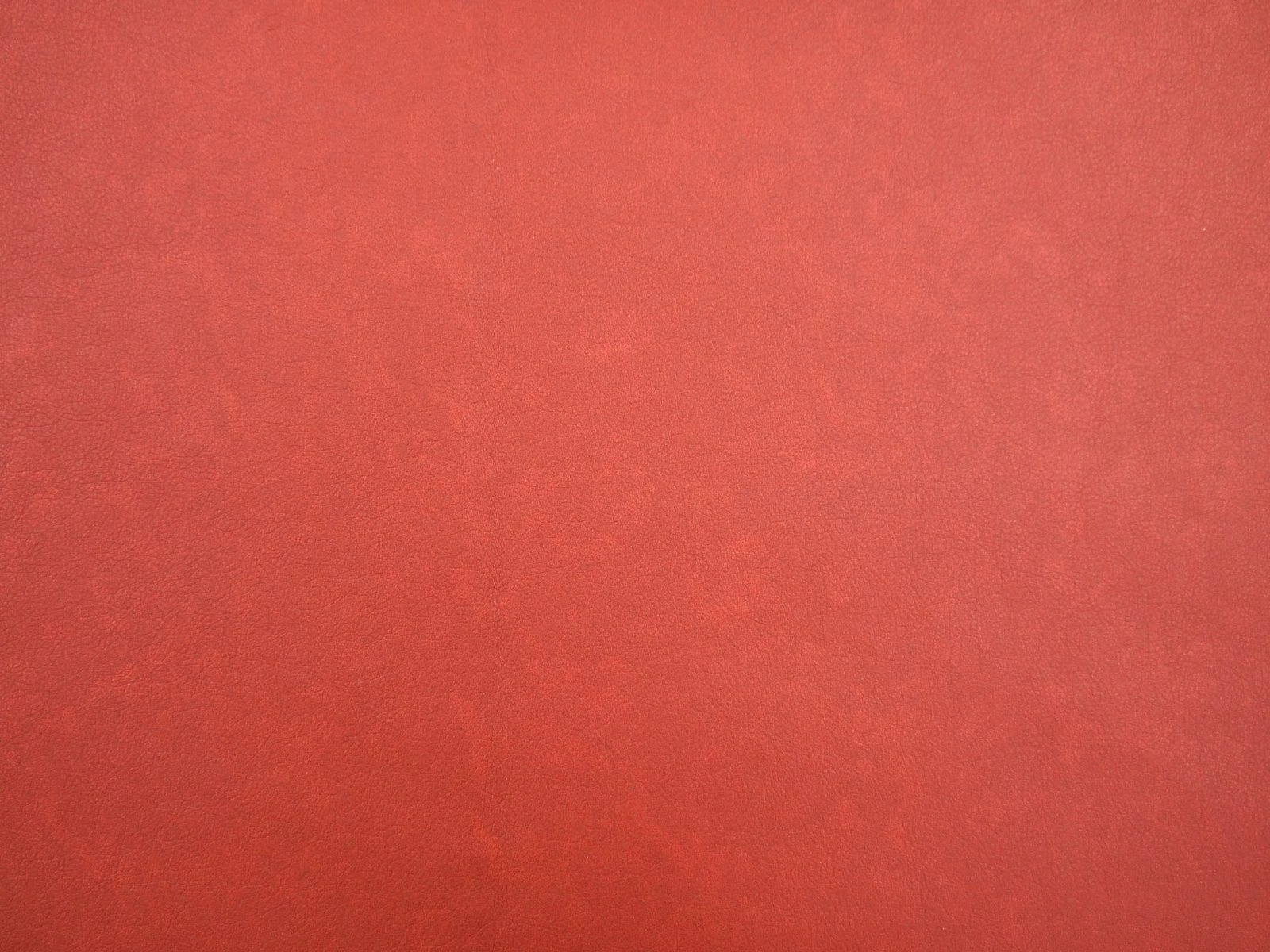 Mottled crimson-red faux leather surface with subtle darker tonal shading