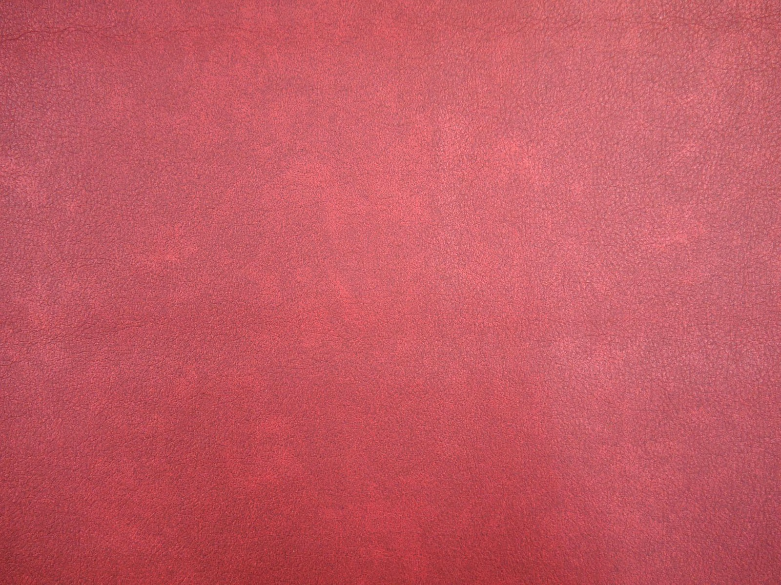 Deep raspberry-red faux leather with softly mottled, lightly grained surface