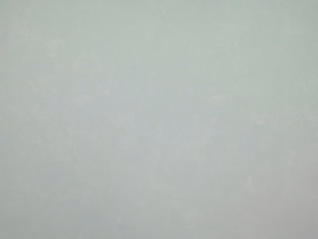 Pale sage-grey faux leather swatch with subtle cloudy mottling and soft sheen