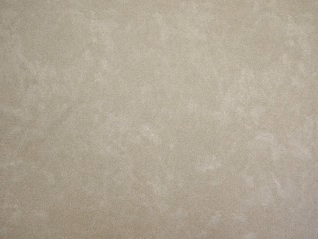 Soft taupe-grey faux leather with cloudy mottling and a gentle surface sheen