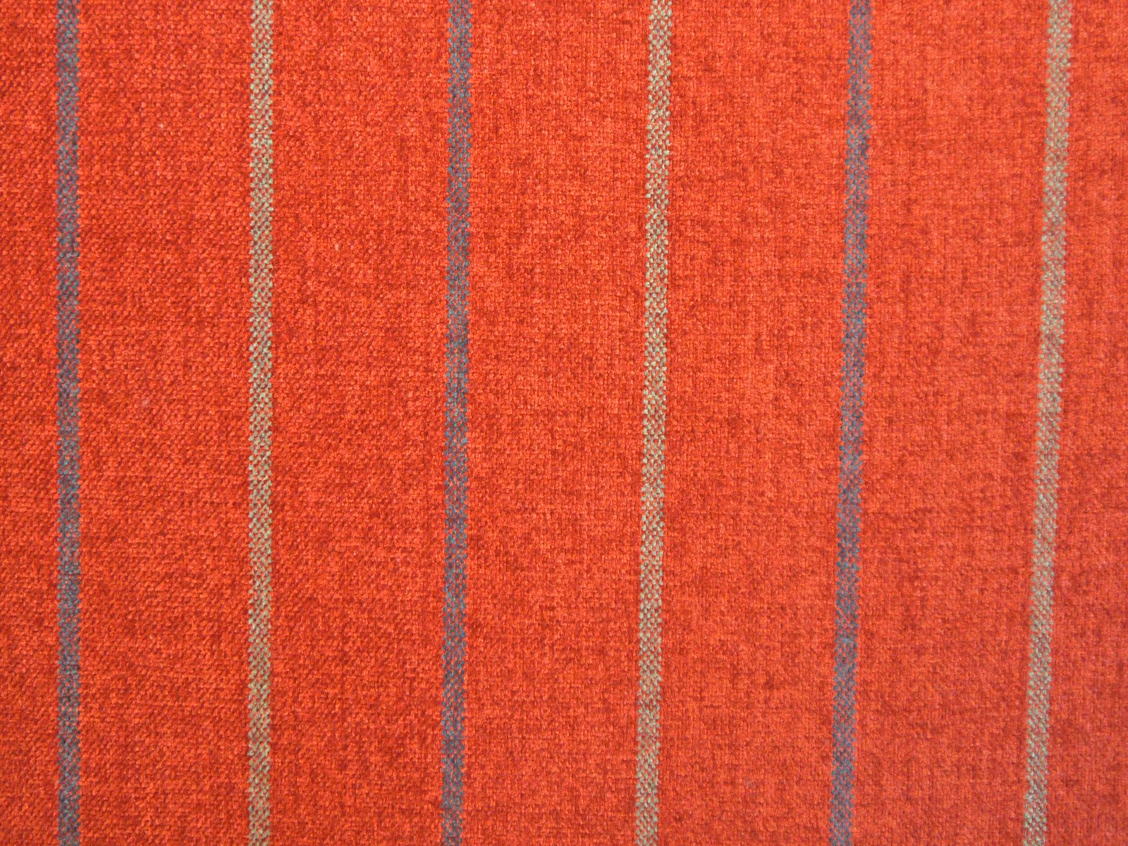 Warm coral-red chenille with muted taupe vertical stripes and nubby texture