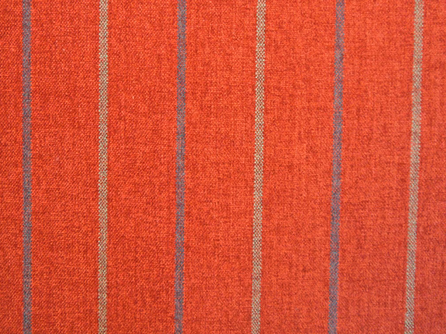 Warm coral-red chenille with muted taupe vertical stripes and nubby texture