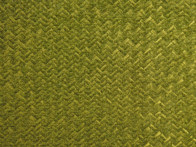 Deep olive chenille with mottled yellow-green chevrons and a tactile pile