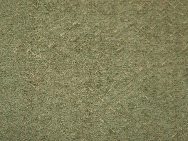 Muted sage-olive chenille with pale broken flecks and a softly pebbled weave