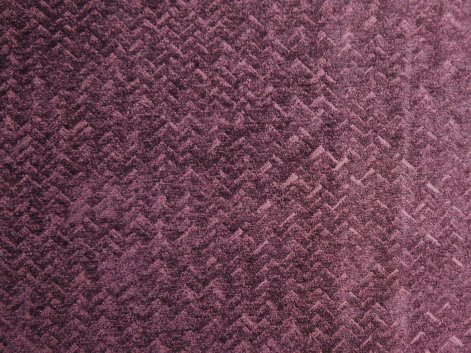Deep berry-plum chenille with tactile broken zigzags and dusty mauve highlights