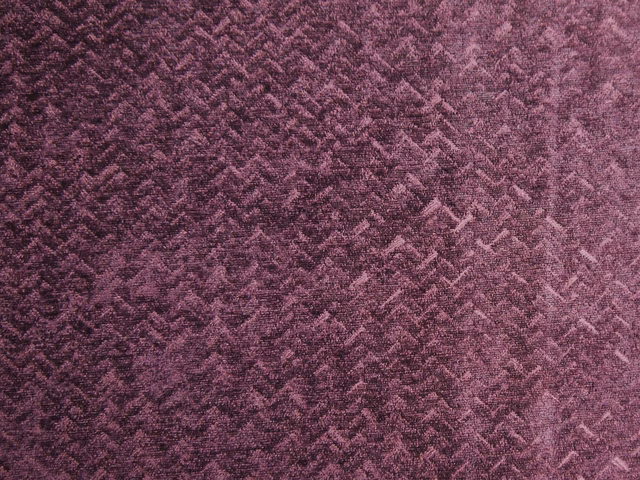 Deep berry-plum chenille with tactile broken zigzags and dusty mauve highlights