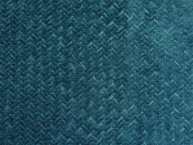 Deep teal chenille with a mottled broken-chevron weave and softly brushed texture