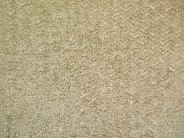 Muted sage-olive chenille with subtle broken chevron texture and softly mottled pile